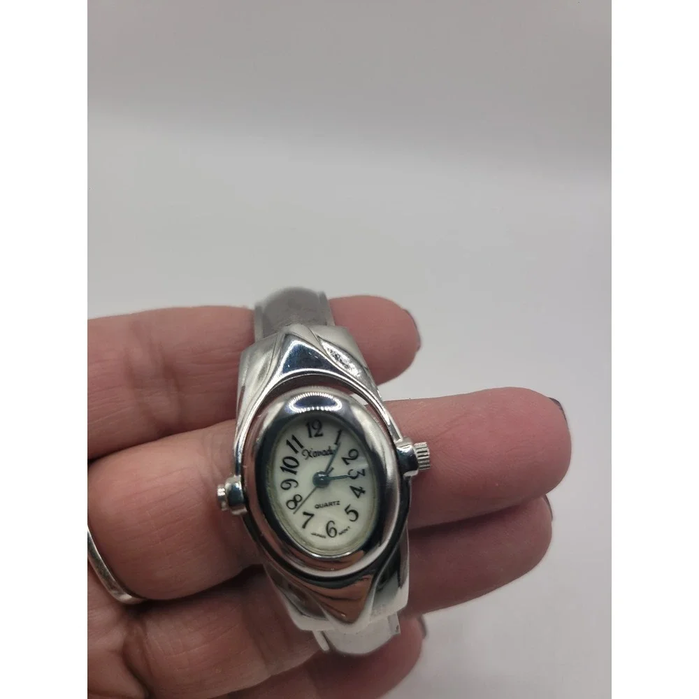 Xanadu Women's Silver Tone Hinged Cuff Bangle Quartz Watch Oval Dial Reverse